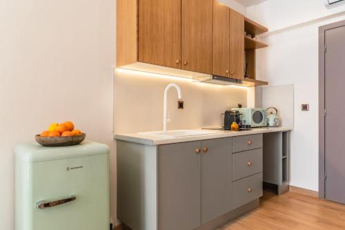 a small kitchen with a sink and a refrigerator at Sun day in Skiathos Town
