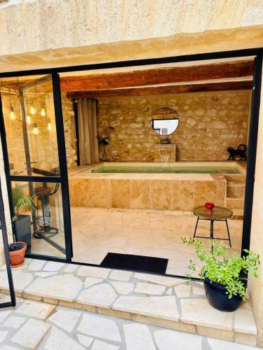 une cour avec un panier de basket dans un bâtiment en pierre dans l'établissement L'Uzétienne- Large residence with pond and patio!, à Pouzilhac