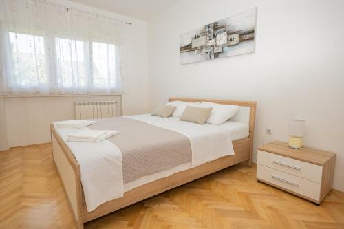 Postel nebo postele na pokoji v ubytování Apartmani Cimerman