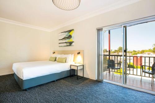 a bedroom with a bed and a balcony at Nightcap at Blue Cattle Dog Hotel in St Marys