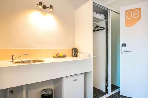 a kitchen with a sink and a counter top at Nightcap at Blue Cattle Dog Hotel in St Marys