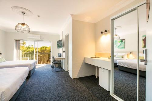 a hotel room with two beds and a mirror at Nightcap at Blue Cattle Dog Hotel in St Marys