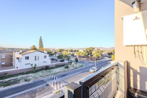 a view of a street from the balcony of a building at Stylish Table View Studio Fully Equipped in Cape Town