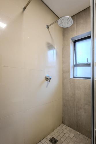 a bathroom with a shower with a glass door at Stylish Table View Studio Fully Equipped in Cape Town