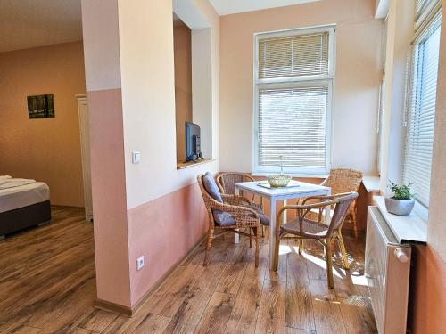 a small dining room with a table and chairs at Villa Utpatel Whg 02 in Ahlbeck