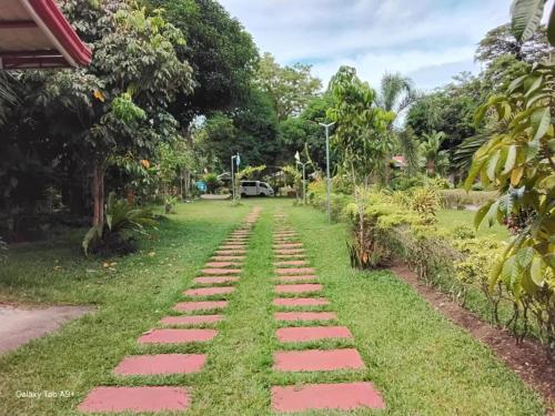 a walkway in the yard of a house at Camiguin Lanzones Resort in Mambajao