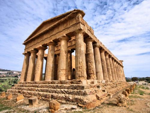 an ancient temple with columns on a hill at Villa Anna by Holiday World in Ravanusa