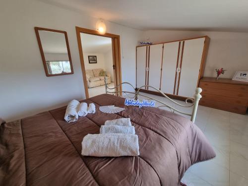 a bedroom with a bed with towels on it at Villa Anna by Holiday World in Ravanusa
