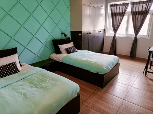two beds in a room with blue walls at FF21- Pods in Bengaluru