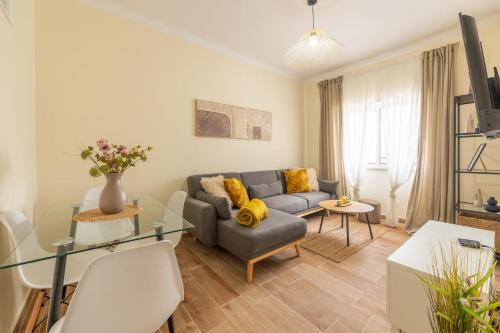 a living room with a couch and a table at GuestReady – Quiet Escape in Setúbal in Setúbal