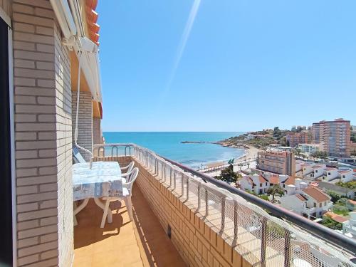 a balcony with a table and a view of the beach at AyF ESPECTACULARES VISTAS DE MORRO DE GOS in Oropesa del Mar