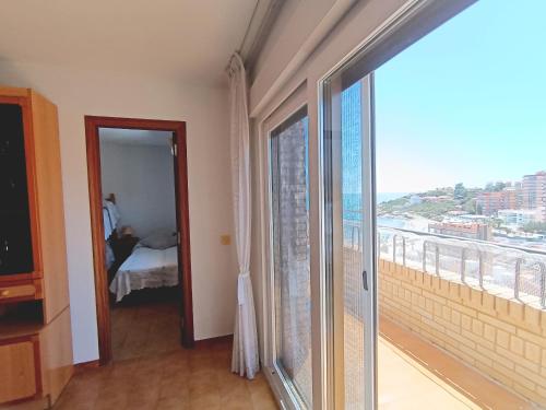 a room with a large glass door leading to a bedroom at AyF ESPECTACULARES VISTAS DE MORRO DE GOS in Oropesa del Mar