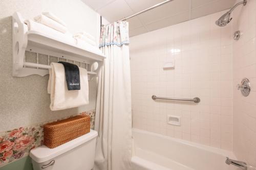 a bathroom with a tub and a toilet and a shower at Boardwalk Plaza Hotel in Rehoboth Beach