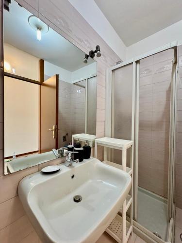 a bathroom with a white sink and a shower at 1Dest - Riva Life in Riva del Garda