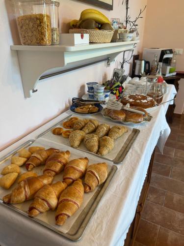 a buffet of pastries and croissants on a table at Monte Cuccolo House B&B in Fontanelice