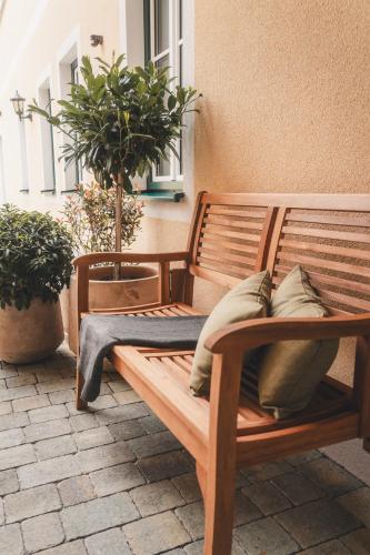 a wooden bench sitting on a patio with plants at Apartments Kienberg in Kienberg