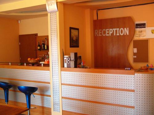 a bar in a restaurant with a reception sign at Family Hotel Jemelly in Obzor