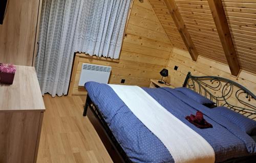a bedroom with a bed in a wooden room at Villa Luna - Ludbreg by Villas Guide in Ludbreg