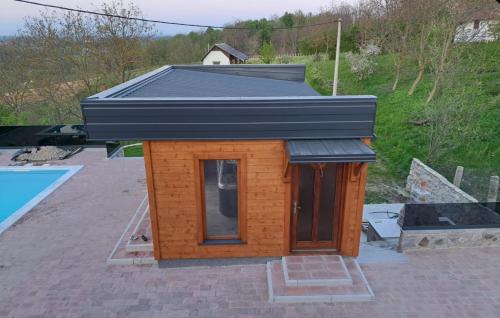 a small house with a black roof on a patio at Villa Luna - Ludbreg by Villas Guide in Ludbreg