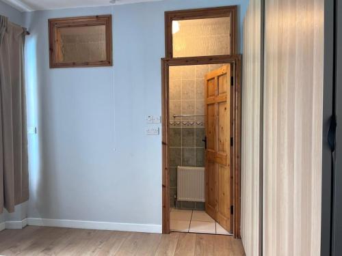 an open door to a bathroom in a room at Cheerful cottage 3-bedroom in Drehidnaraga Bridge