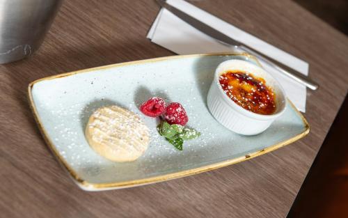 a plate of food with a dessert on a table at The View Hotel in Eastbourne