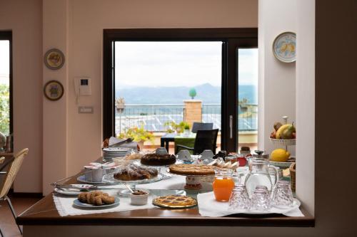 a table with food and orange juice on it at B&B Bella Vista in Valguarnera Caropepe