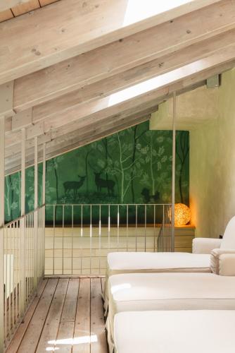 a room with four beds and a mural of animals at Auberge de La Maison in Courmayeur