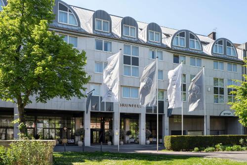 a building with flags in front of it at Brunfels Hotel, in the Unbound Collection by Hyatt in Mainz