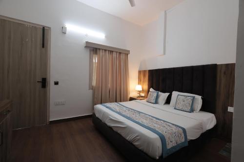 a bedroom with a large bed in a room at Staybook The Rudveda Resort - Free High Tea near Pool Area in Rāmnagar