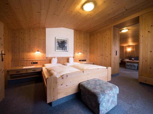 a bedroom with a large bed in a wooden room at Ferienwohnungen Egger in Fügen