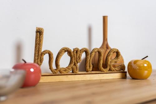 a wooden sign with two apples on a table at Vila Lux 3 in Rijeka