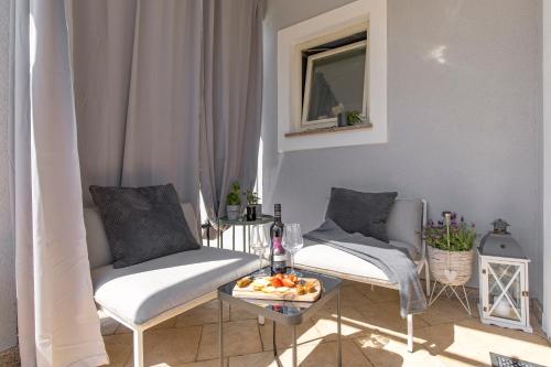 a living room with two chairs and a table at Vila Lux 3 in Rijeka