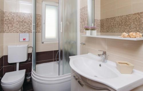 a bathroom with a toilet and a sink and a shower at Villa Rania - Korcula by Villas Guide in Blato