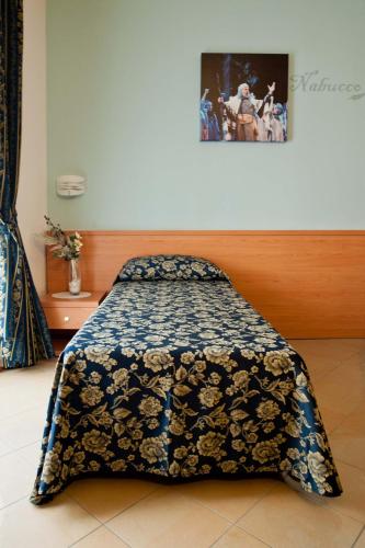 a bed in a room with a blanket on it at Casa Citella in Bussolengo