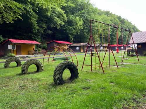 an outdoor playground with a monkey bars and a swing set at ATC Kemp Kajlovec in Hradec nad Moravici