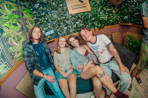 a group of people sitting on a bed in a room at London Backpackers Youth Hostel 18 - 35 Years Old Only in London