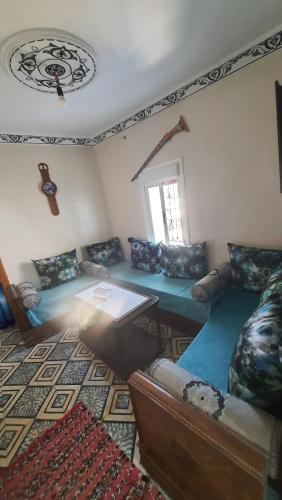 a living room with a couch and a table at Hostel ALINE in Chefchaouene
