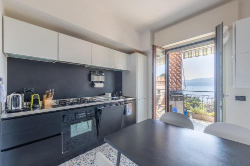a kitchen with a counter and a table and a window at Blue Dream in Ispra