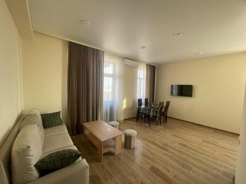 a living room with a couch and a table at Apartment hotel in Yerevan in Merdzavan