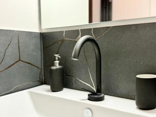 a kitchen sink with a faucet and a soap dispenser at La Terrazza di San Salvi in Florence