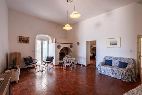 a living room with a couch and a table and chairs at Casa sul Mare by Rentbeat in Vieste