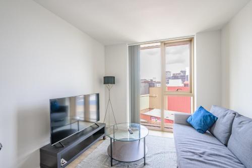 a living room with a couch and a glass table at Stunning Central Birmingham1 Bedroom Apartment in Birmingham