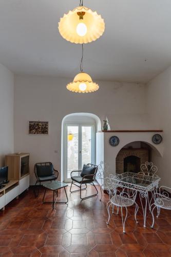 a living room with a table and chairs and a fireplace at Casa sul Mare by Rentbeat in Vieste