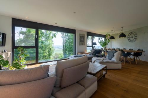 a large living room with couches and a table at Le Rive Sud in Estavayer-le-Lac