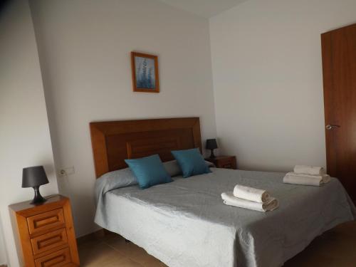 a bedroom with a bed with towels on it at Apartamentos Plaza in Nerja