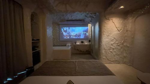 a room with a tv on the wall of a room at Dragonfly Hotel - The Art Hotel in Mumbai