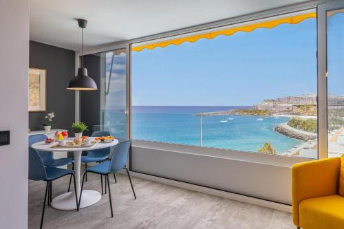 a dining room with a view of the ocean at Doñana 1006 by VillaGranCanaria in Mogán