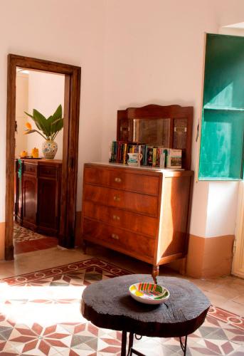 a living room with a dresser and a coffee table at Agriturismo Boccadifuoco in Motta Camastra