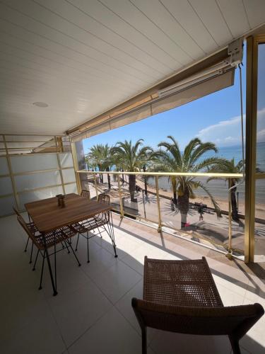 a balcony with a table and chairs and a view of the beach at Salou SEA SUNSET in Salou