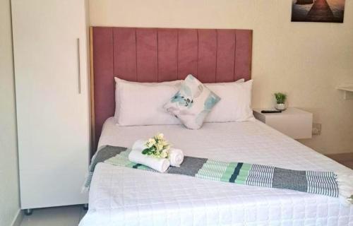 a bed with two towels and two stuffed animals on it at Glamour C-rane lodge in Phalaborwa